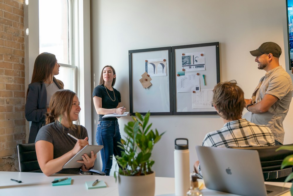 A small team meeting in a sunlit office